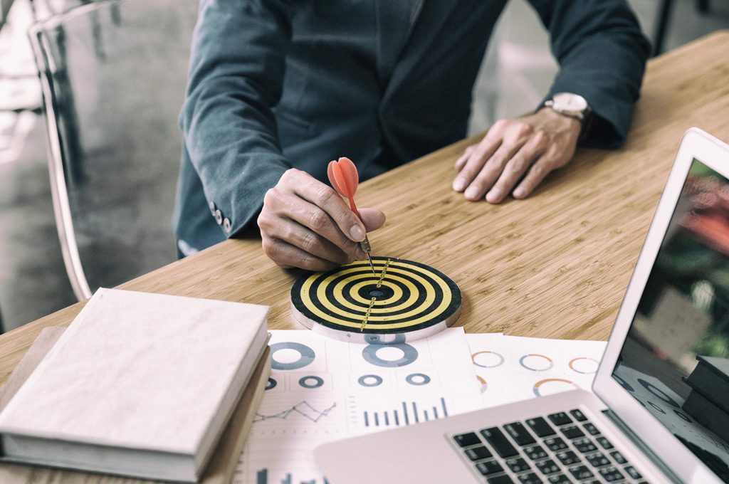 midsection man holding dart dartboard while sitting